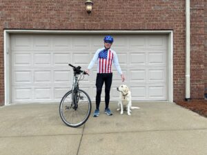 mike hynes posing with dog and bike